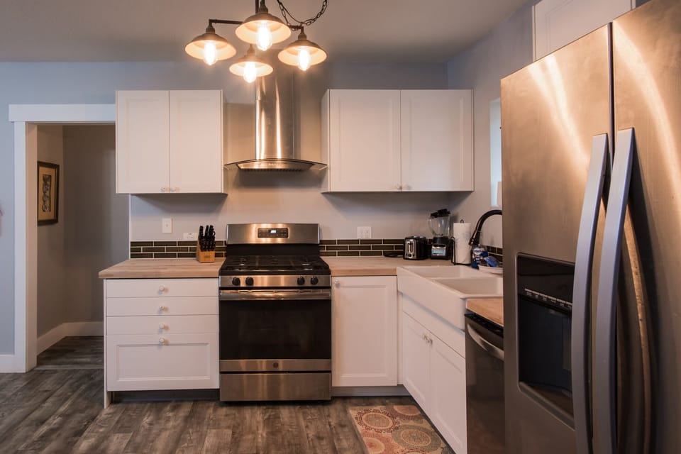 Fully outfitted stainless kitchen with new gas range.