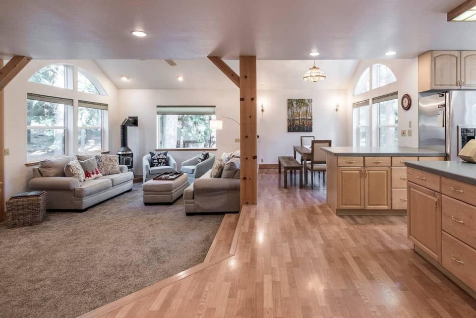 Inviting open floor plan, with large windows capturing beautiful forested views