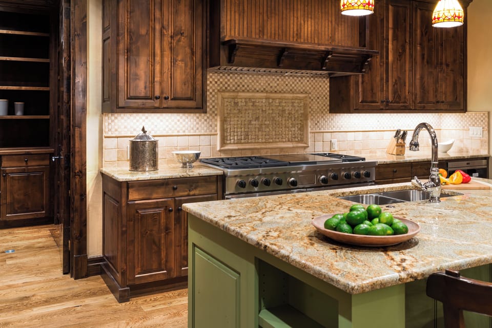 Step into your dream kitchen where rich wood cabinetry and granite countertops create the perfect space for culinary adventures. Fresh limes await your morning smoothie while professional appliances stand ready for your next feast.