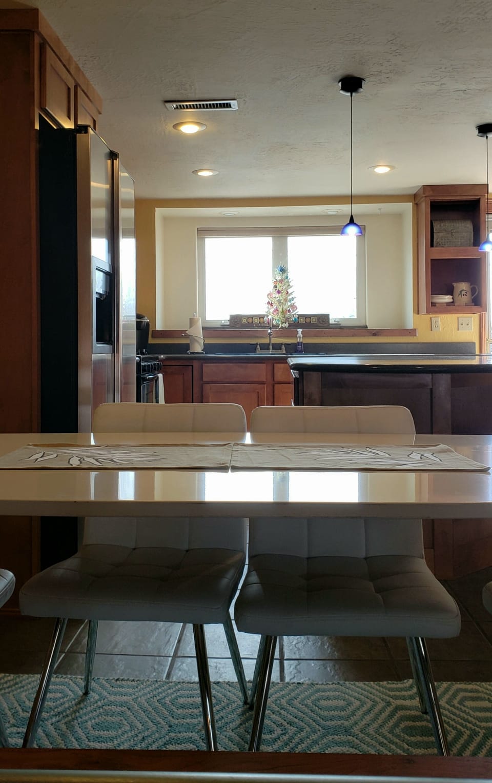 Kitchen Dining room table sits up to six adults with additional chairs