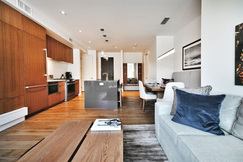 Throw pillows in the living room accent the wooden finishes beautifully