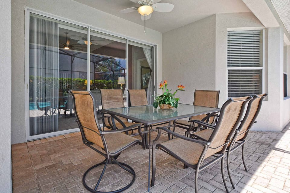 Lanai features a ceiling fan for keeping cool on hot summer days (note this patio set has been replaced with a circular table that seats 4).