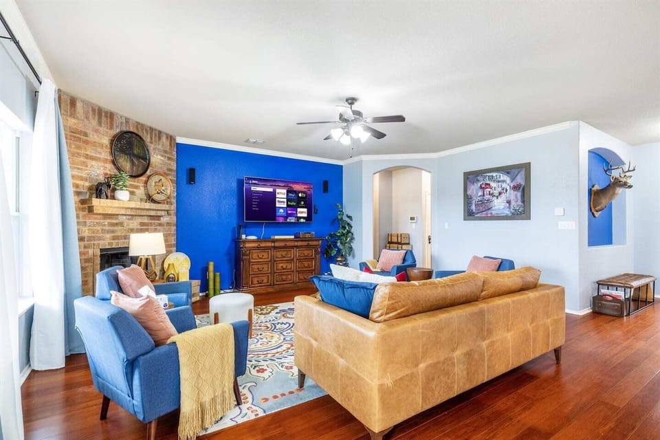 Living room with fireplace, and view of the pool