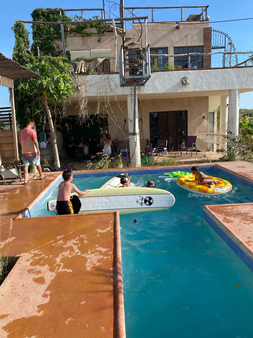Families in the pool! Main house in the background which is also a rental. 