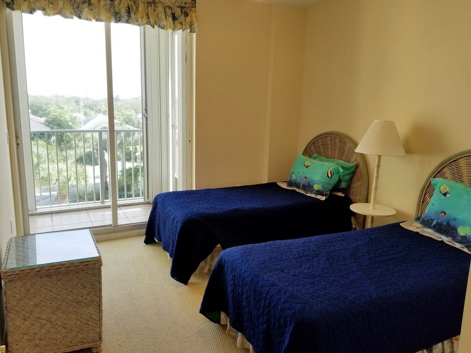 Twin Beds in bedroom facing east with balcony
