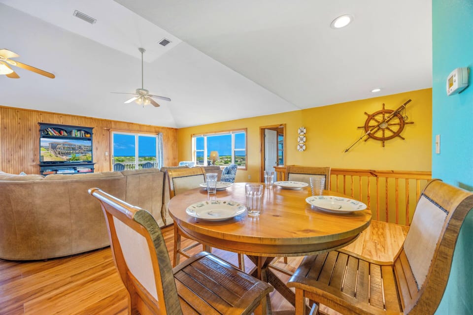 Gather around your dining table and enjoy meals with ocean breezes and coastal charm surrounding you—this bright, cheerful space invites easy conversation and relaxation.