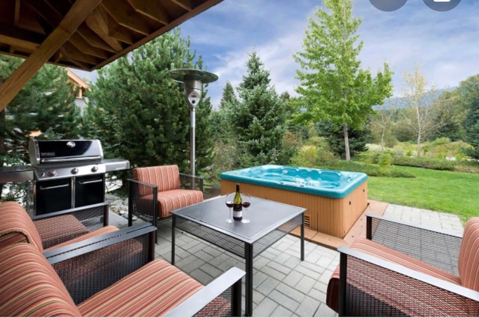 SUMMER shot of the back deck, hot tub and grill (note not set up like this in winter)