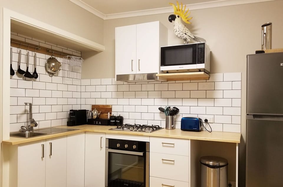 The kitchen has all you need - coffee maker, free breakfast supplies & seating.