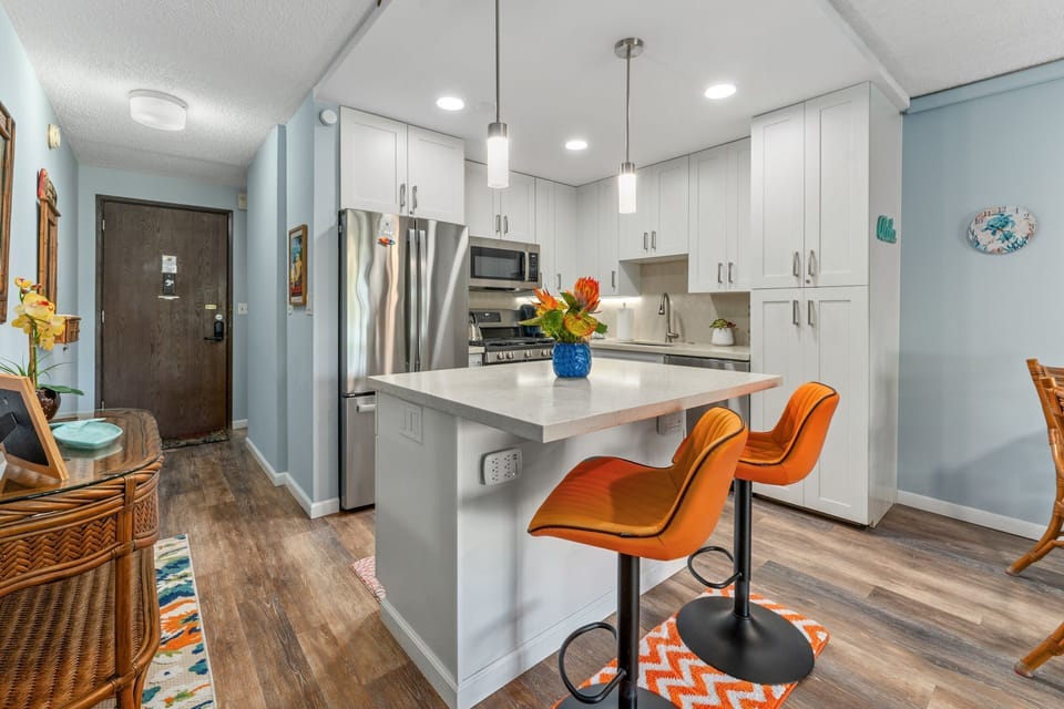 Gorgeous, well stocked newly remodeled kitchen with all your culinary needs.  Dine at the quartz counter/bar, dining table or on the private lanai.