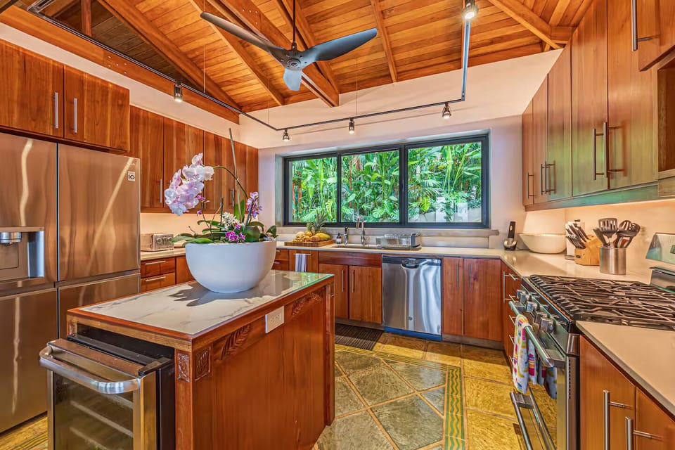 Fully equipped kitchen with warm wood cabinetry for easy, enjoyable cooking