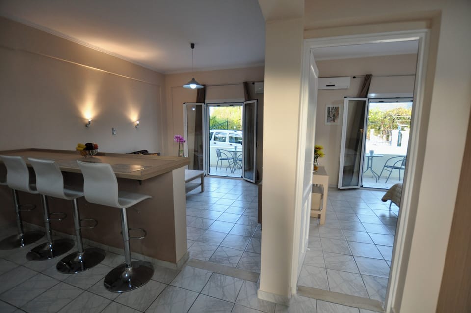 The layout combines the kitchen, dining, and living area and a private bedroom
