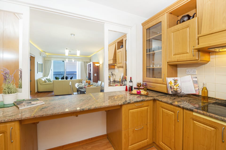 fully equipped kitchen with window overlooking the dining area