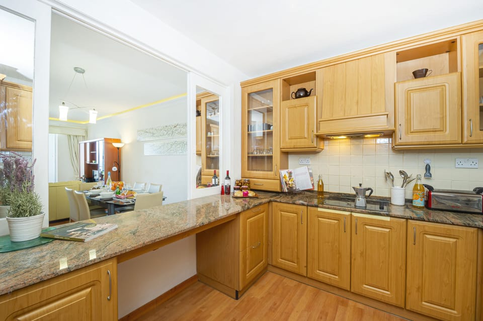 fully equipped kitchen with window overlooking the dining area