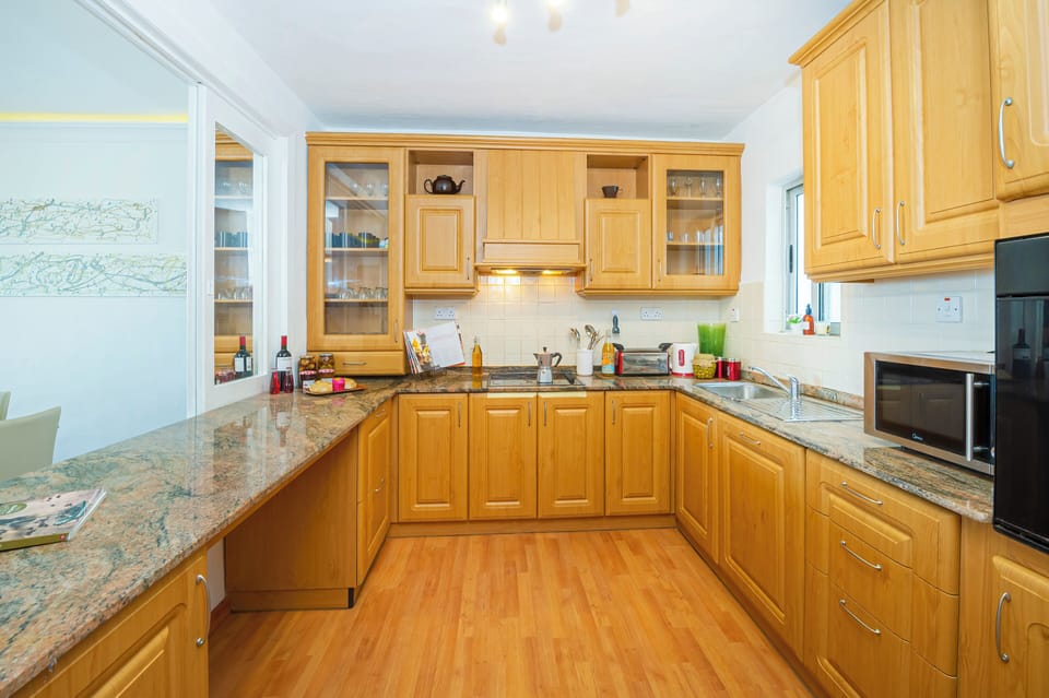 fully equipped kitchen with window overlooking the dining area