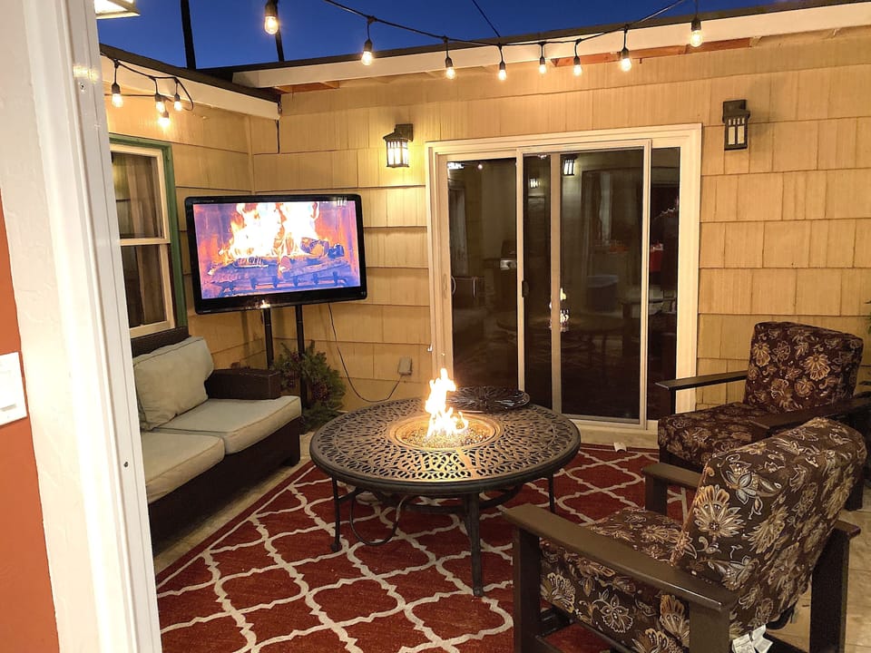 Intimate back yard with deep seating, fire pit and outdoor TV
