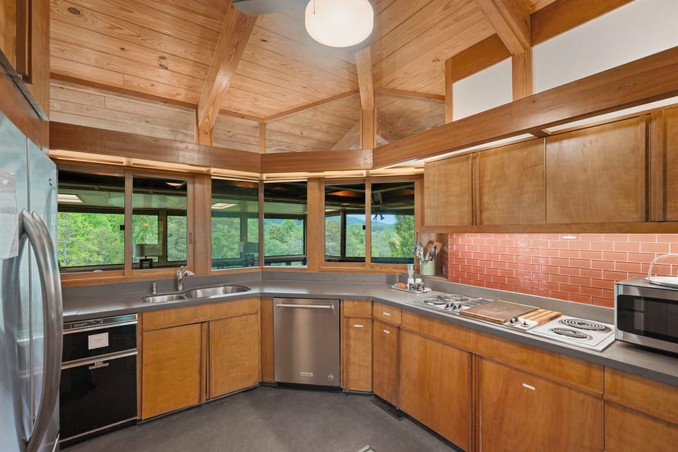 North-facing wraparound window band, oxblood glass tile and faceted ceiling