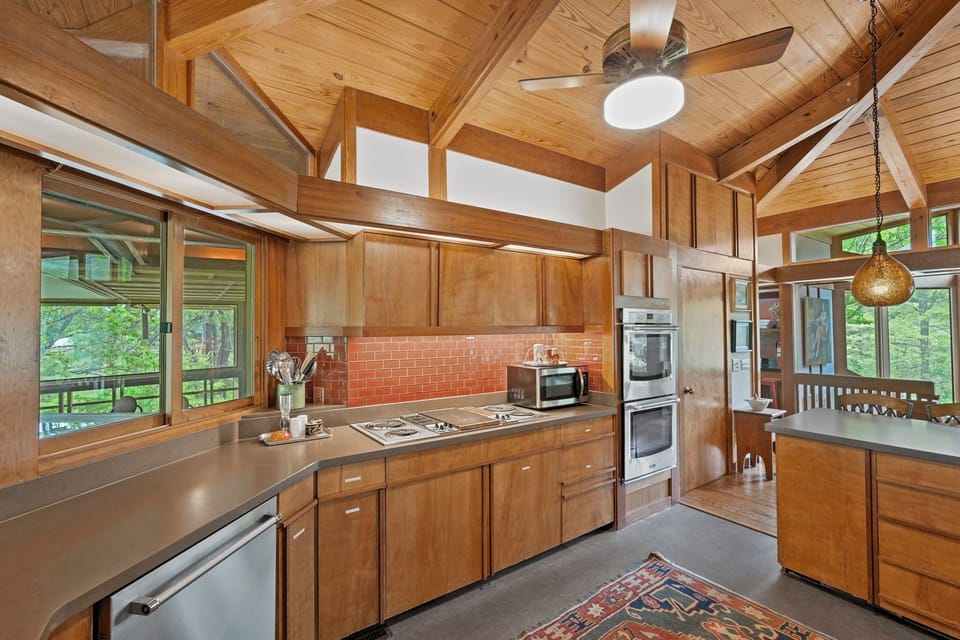 Clerestory light boxes, figured veneer cabinetry, double wall oven, peninsula.