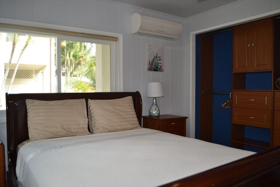 The third bedroom features a queen sleigh bed, TV, and AC for comfort.