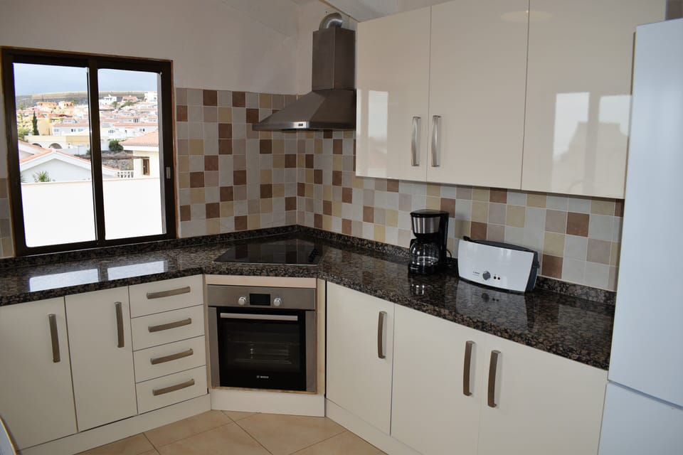 Fully equipped kitchen with oven, microwave, dishwasher, coffee maker, toaster. 