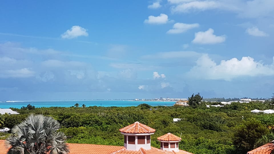 Your view from the veranda, showing the beach in the background.  5 minute walk!