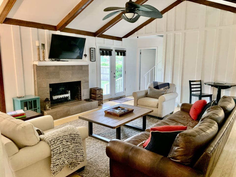 Living room with comfortable seating and Roku-equipped TV
