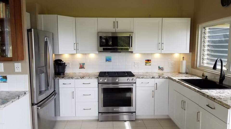Modern kitchen with granite countertops, & new refrigerator, range, & microwave