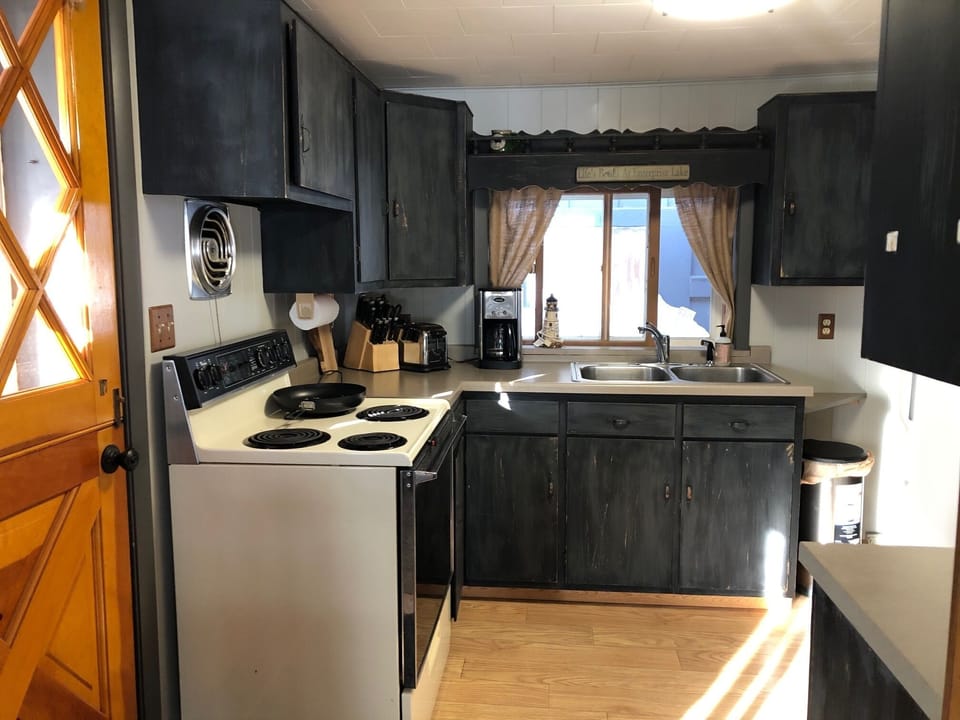 Kitchen with stove, oven, refrigerator and microwave. 