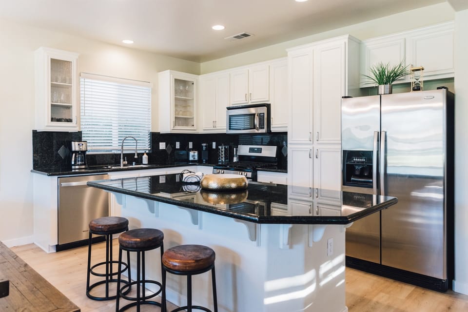 Step into a culinary haven where the kitchen is fully equipped for all your gourmet adventures. Open to a cozy living area and stunning views of the golf course—perfect for relaxing and entertaining.