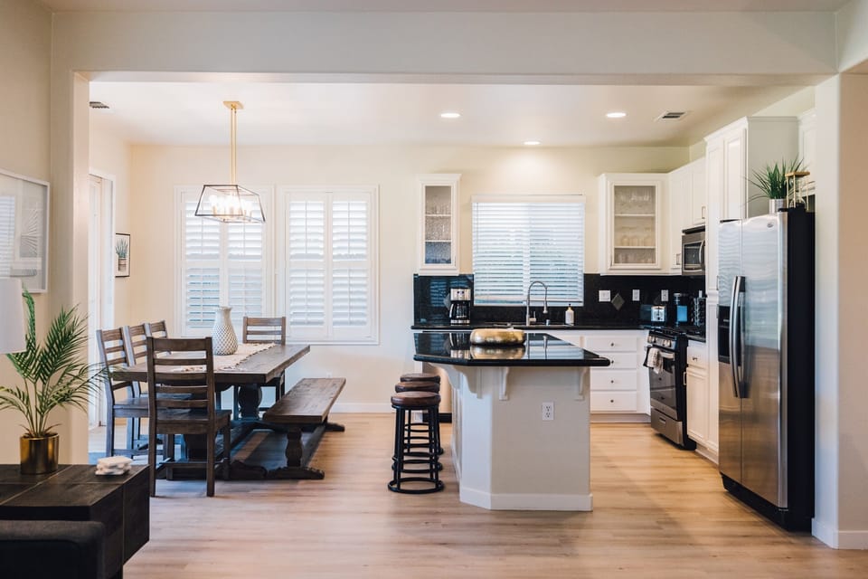 Step into a culinary haven where the kitchen is fully equipped for all your gourmet adventures. Open to a cozy living area and stunning views of the golf course—perfect for relaxing and entertaining.
