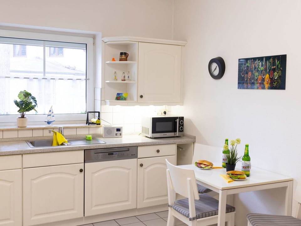 Furniture, Kitchen, Kitchen Appliance, Cabinetry, Interior Design, Countertop, Major Appliance, Flooring, Cupboard, Floor