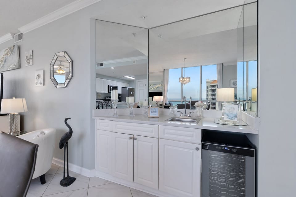 Cabinet features a sink and a refrigerator to chill your wine.