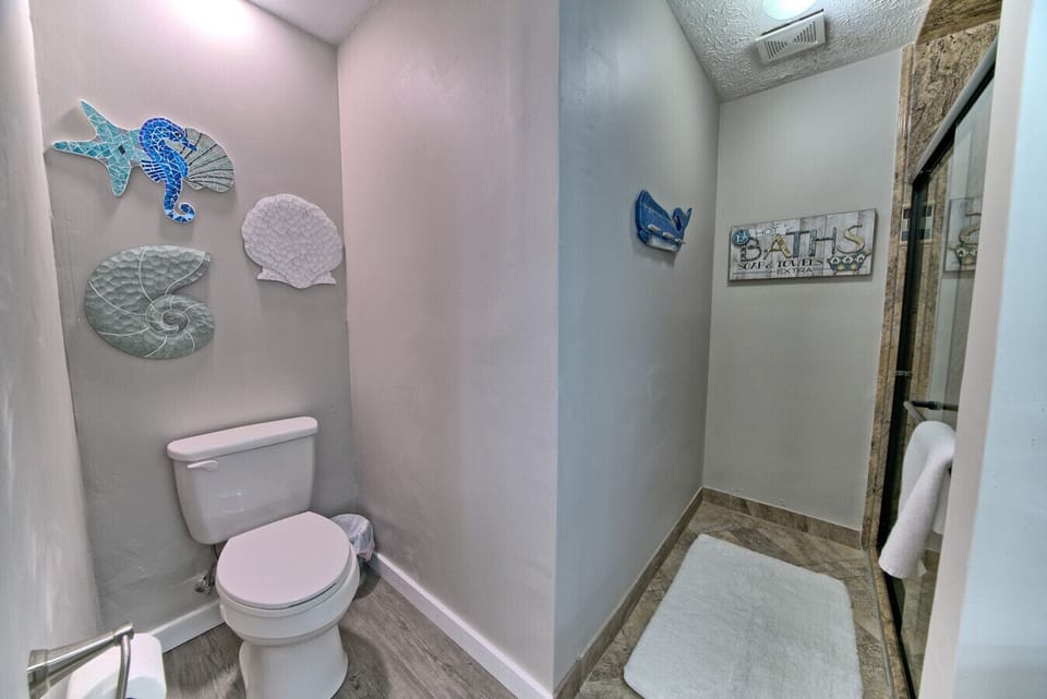 This charming bathroom combines coastal accents with a modern touch, offering a cozy and inviting retreat