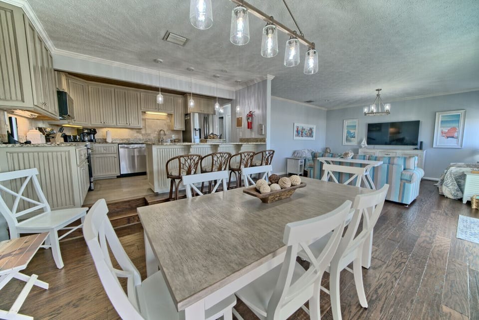 This open-concept kitchen and living area combines modern amenities, cozy seating, and a welcoming space perfect for group gatherings