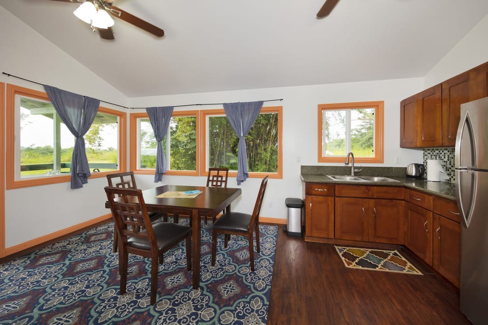 Bright and sunny dining area with functional kitchen, fresh chicken eggs, fruit
