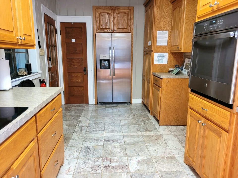 Marble floor & backsplash, custom cabinetry, new appliances