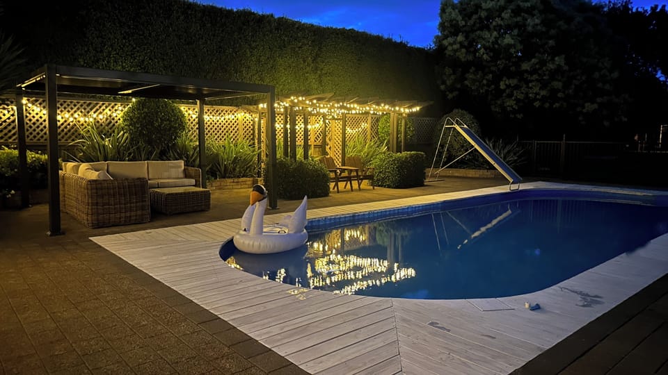 The pool is beautifully lit at night and we have the comfiest outdoor couch ✨