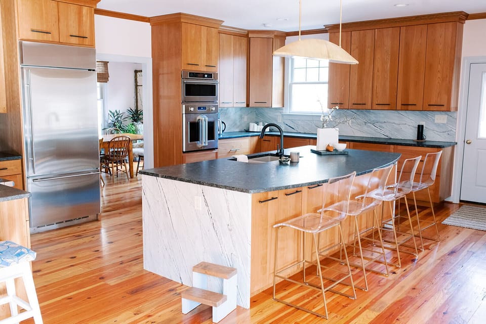 The spacious kitchen features commercial grade stainless steel appliances