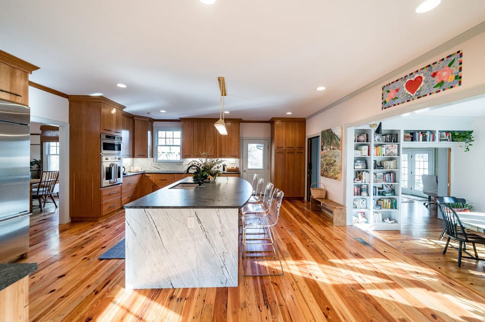 Back downstairs, the kitchen leads into a breakfast nook and additional suite 