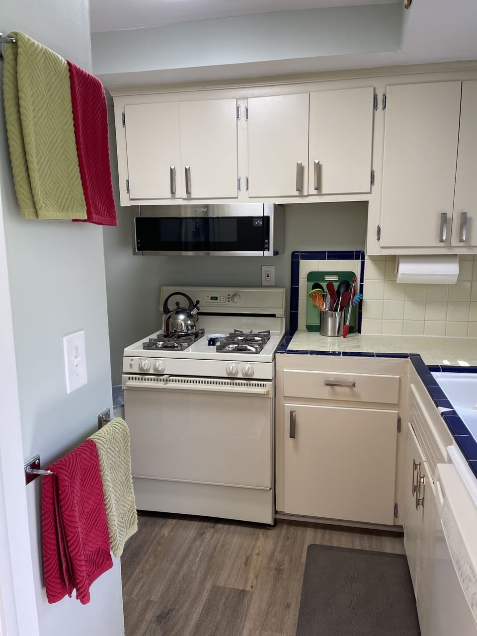 Gas stove with under the counter stainless microwave.