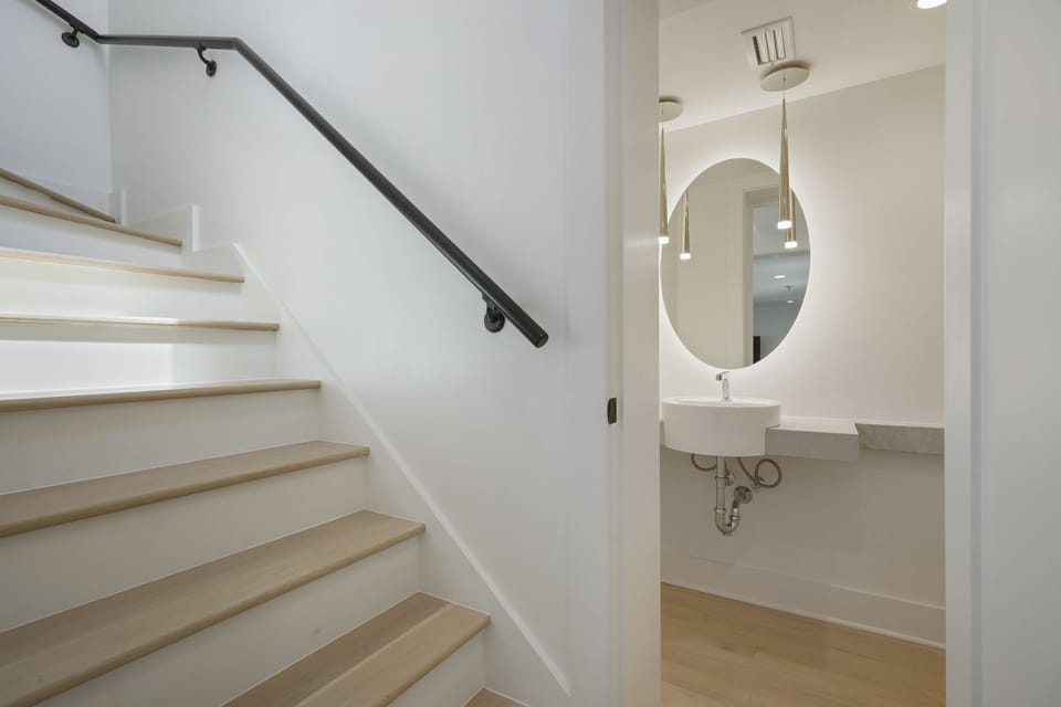 VIEW OF HALF BATH AT BASE OF STAIRS TO SECOND LEVEL