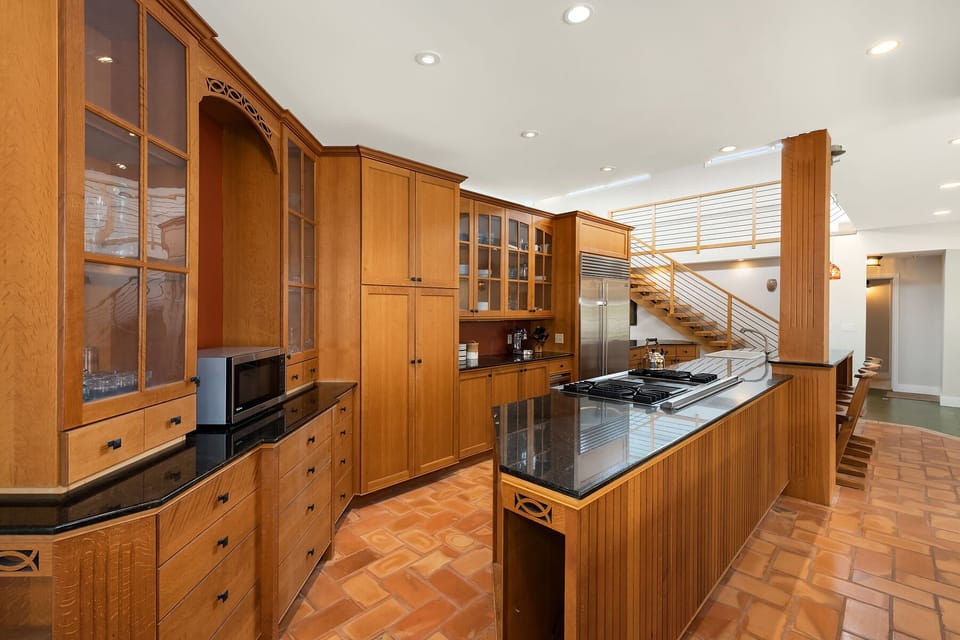 Open-concept kitchen and living space with warm wood finishes.