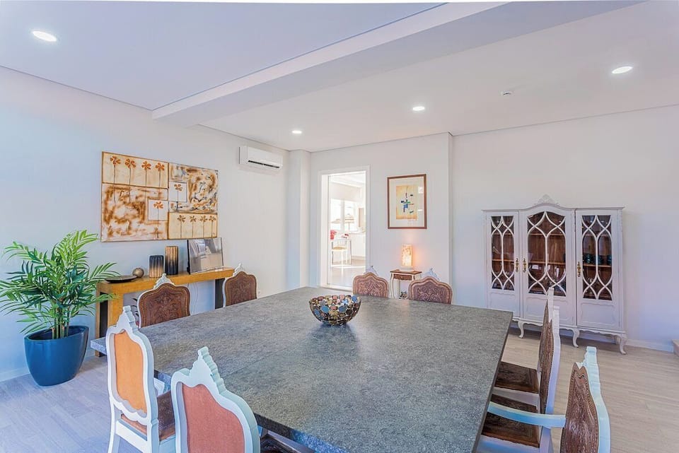 Elegant dining room with grey stone table — Villa Mena, luxury holiday villa in Charneca da Caparica