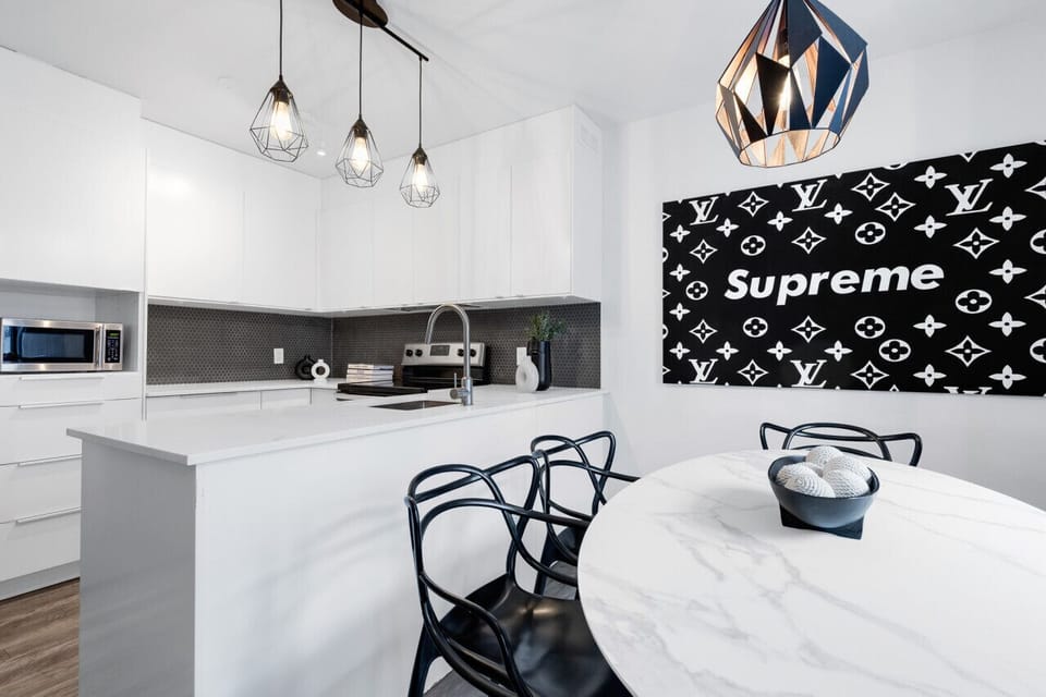 Dining Room: Featuring luxurious dining table with comfortable chairs, and a Smart TV, fully equipped for you to prepare and enjoy large group events.
