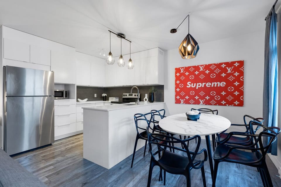 Dining Room: Featuring luxurious dining table with comfortable chairs, and a Smart TV, fully equipped for you to prepare and enjoy large group events.