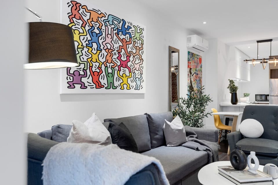 Living Room: Features a queen-size sofa bed with Art Deco design, two armchairs, and a Smart HD TV with access to Netflix, YouTube, and Prime.