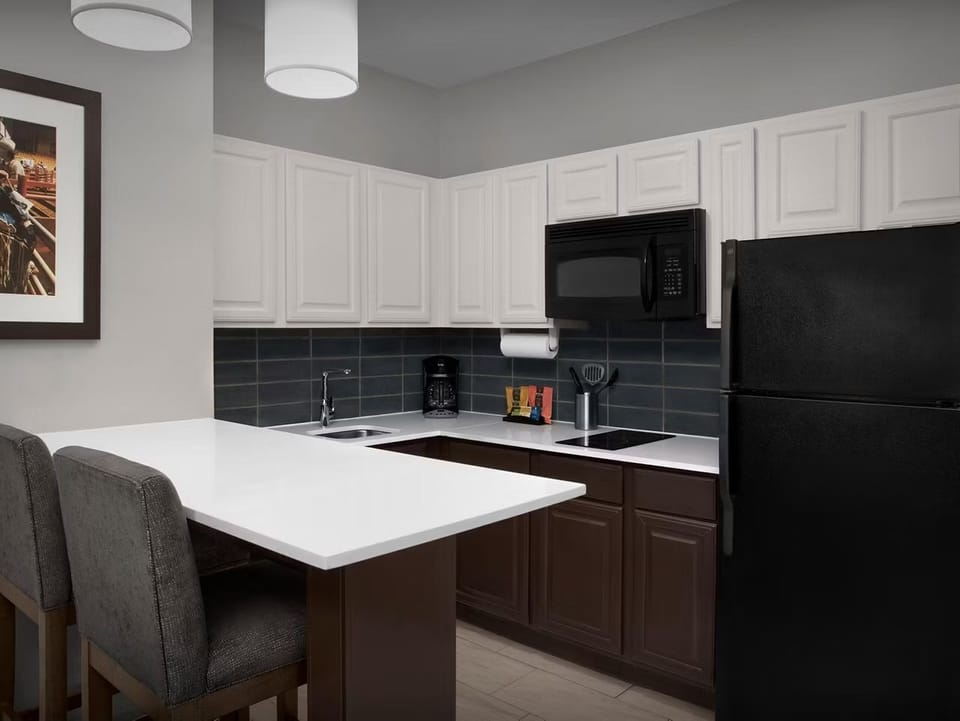 Spacious kitchen with breakfast bar and modern appliances.