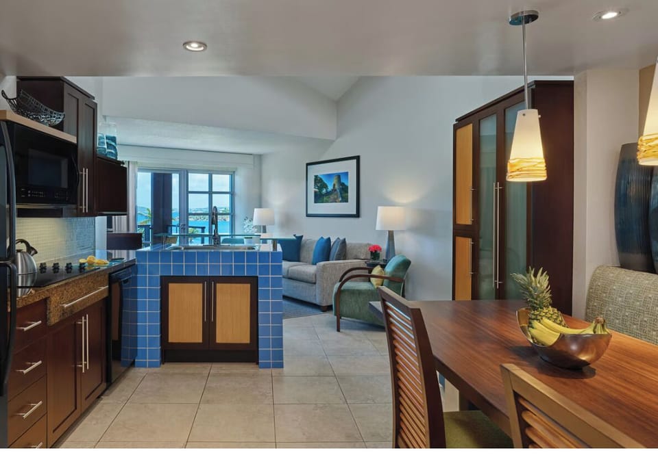 Kitchen and banquet dining with open duplex living space opening to terrace. 