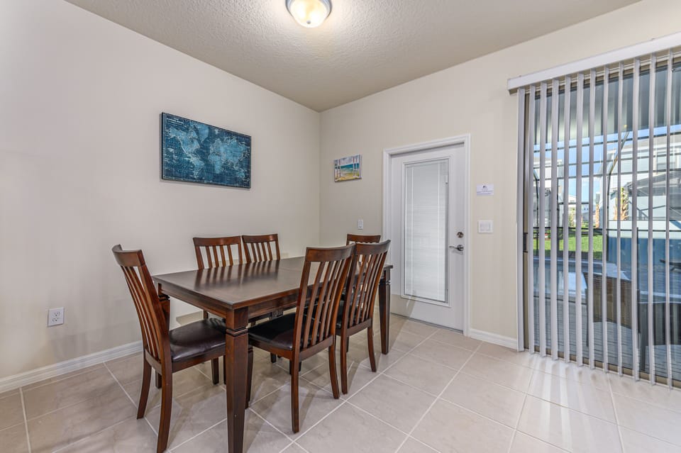 Classic dining table with sliding glass door access to patio