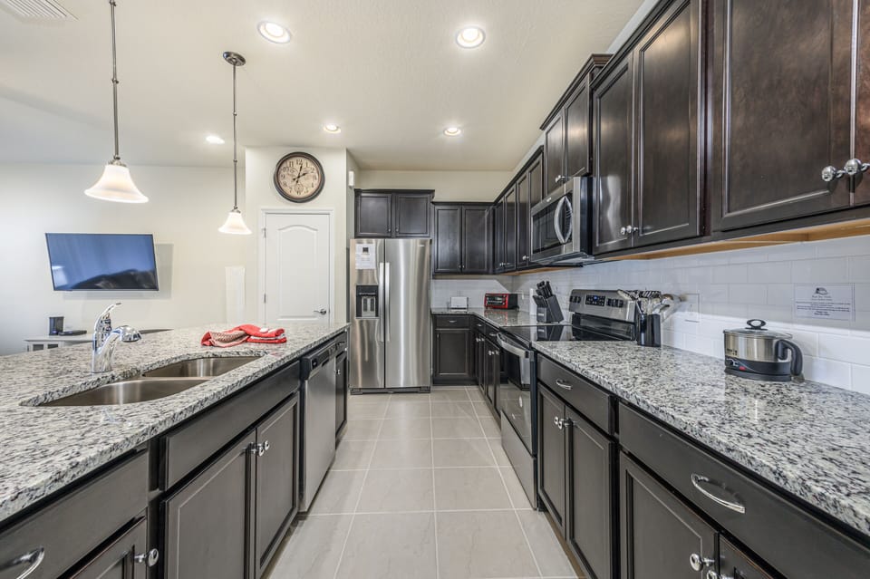 View 3 of beautiful modern style kitchen with microwave, stove, oven, and dishwasher