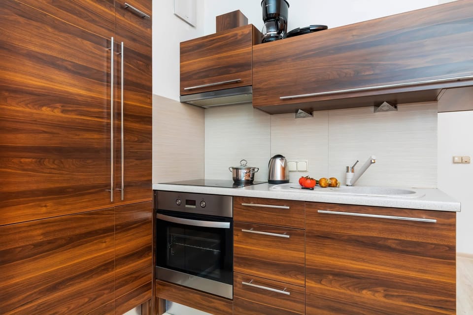 Kitchenette with oven and refrigerator. 